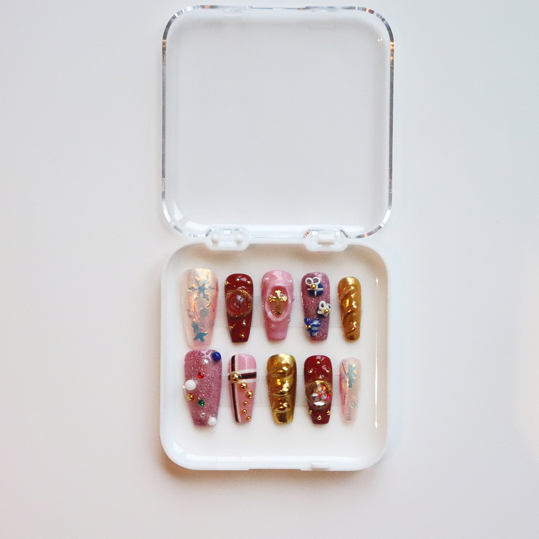 Decorative false nails in a clear case on a light background